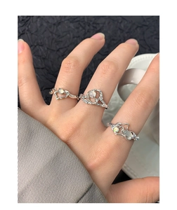 Detailed macro of irregular S925 silver liquid heart rings with translucent stones