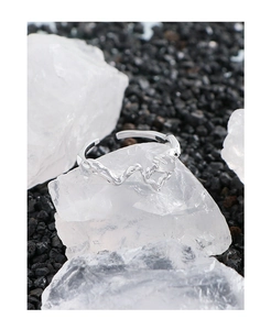 Macro shot of silver irregular wave ring with white agate stone on white crystal stone