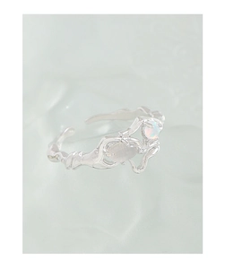 Close-up of S925 silver irregular textured ring with oval opal and iridescent stone
