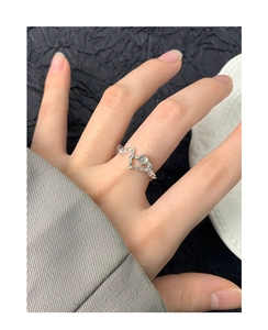 Detail of S925 silver irregular wave ring featuring a glowing moonstone on finger
