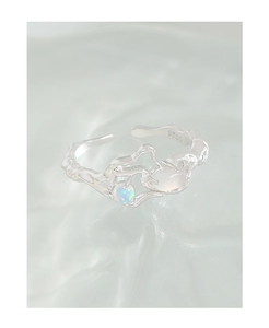 Detailed shot of S925 silver ring with irregular texture, opal and moonstone gems