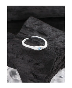 Macro view of S925 sterling silver ring featuring a blue eye-cut cubic zirconia stone