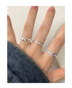 Close-up of S925 silver ring set with pink heart stone and purple zircon on finger