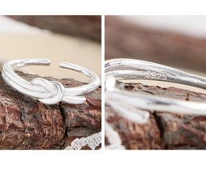 Detailed view of S925 sterling silver knot ring with inner hallmark and polished finish
