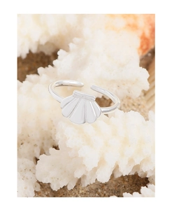 Detailed close-up of S925 sterling silver seashell ring on white coral with sand