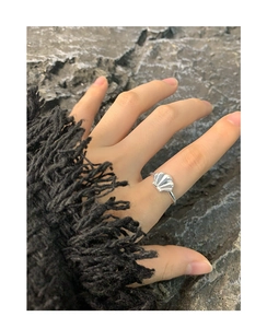 Macro detail of S925 sterling silver shell ring showing natural texture on a model hand