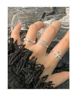 Close-up of S925 sterling silver starfish and heart ring set with zircons on model hand
