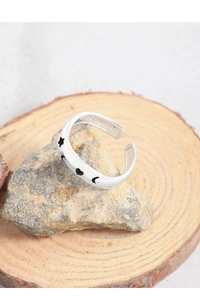 Detail shot of S925 sterling silver ring showing star and moon engraving on stone base