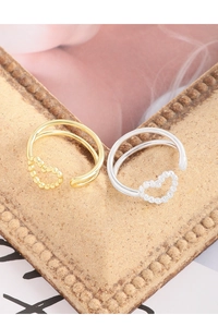 Close-up of gold and silver S925 double-line rings with hollow heart design