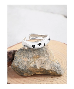 Close-up of S925 silver open ring featuring black enamel stars and moon patterns