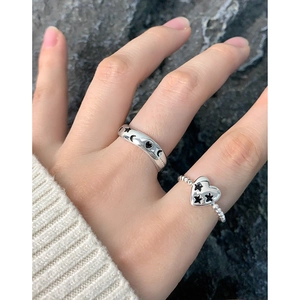 S925 silver rings with graffiti stars and moon motifs on a dark stone background