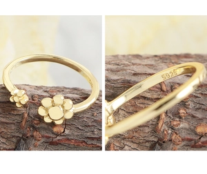 Detailed macro view of S925 hallmark on minimalist gold flower ring for women
