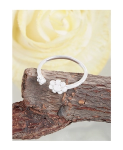 Close-up of S925 silver open ring with cute animal paw prints on natural tree bark
