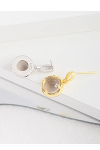 Detail of S925 sterling silver stamp on smoky quartz drop earrings with textured finish