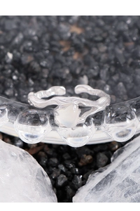 Macro detail of S925 silver ring with lava texture and heart-shaped opal gemstone