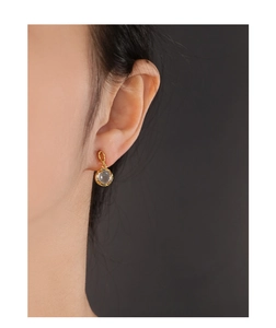 Detail view of S925 silver ear studs with wrinkled gold texture and natural smoky quartz
