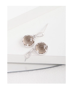 Macro shot of S925 sterling silver earrings with textured round brown smokey crystals