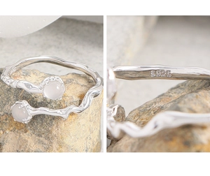 Detail of S925 sterling silver ring with irregular twig texture and white gemstones