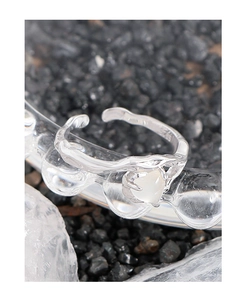 Macro view of textured S925 silver wave ring featuring a heart-shaped opal gemstone