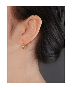 Close-up of S925 silver stud earring with textured gold rim and natural smoky quartz bead