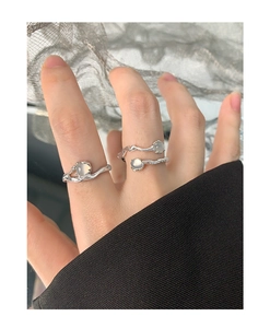 Detailed view of S925 sterling silver rings with organic wavy texture and moonstone gems