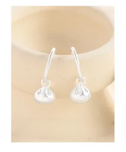 Close-up of S925 sterling silver lucky bag drop earrings hanging on a ceramic bowl