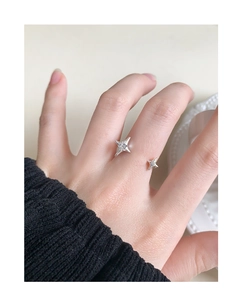 Close-up of S925 sterling silver star ring with zircon stones worn on finger
