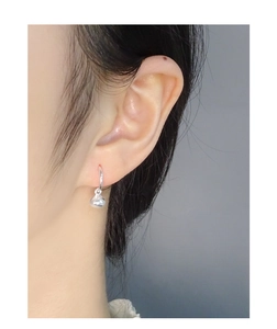 Close-up of minimalist S925 sterling silver waterdrop earrings on a female model