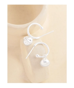 Detailed macro shot of S925 sterling silver hoop earrings with polished spheres