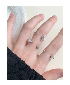 Macro detail of S925 silver star rings with sparkling zircon inlay for women