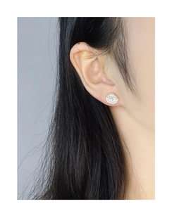 Close-up of elegant S925 silver baroque pearl earring with crystal on model ear