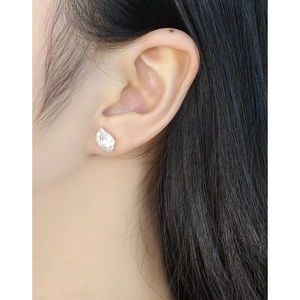 Elegant S925 sterling silver baroque pearl studs on model with a minimalist design