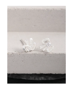 Detail macro view of bow ribbon S925 sterling silver stud earrings with zircon