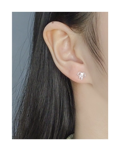 Close-up of minimalist S925 silver bow stud earrings with sparkling cubic zirconia
