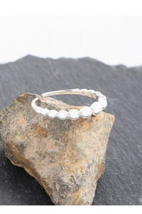 Detailed view of S925 sterling silver ring with gradient beads on a textured stone