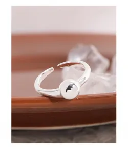 Macro shot of minimalist S925 sterling silver open ring with a polished sphere detail