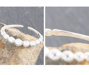 Detailed close-up of S925 sterling silver hallmark on gradient bubble band ring