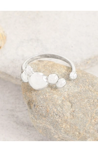 Macro shot of S925 sterling silver ring with bubble spheres on natural stone background