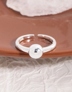 Macro shot of minimalist S925 sterling silver open ring with smooth silver bead detail