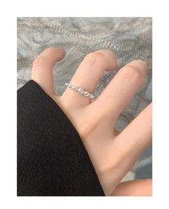 Close-up of minimalist S925 sterling silver beaded ring on model finger for styling