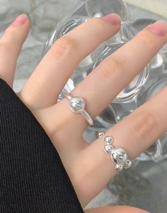 Detail of 925 sterling silver minimalist beaded ring on model with polished finish
