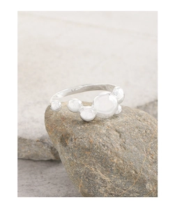 Detailed view of S925 sterling silver stamp on minimalist polished bubble ball ring