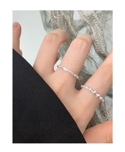 Detail of S925 sterling silver beaded rings set with a polished minimalist finish