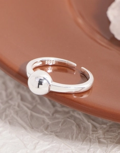 Macro shot of S925 sterling silver ring showing the metal hallmark and polished bead