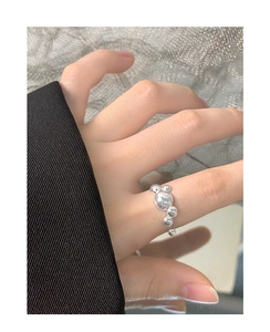Close-up of S925 sterling silver bubble ring with polished spherical beads on hand