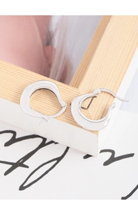 Macro shot of irregular U-shaped S925 sterling silver earrings with polished wavy design