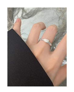 Close-up of S925 sterling silver ring with irregular lava design on a hand model