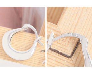 Close-up of S925 sterling silver U-shaped hoop earrings showing hallmark detail