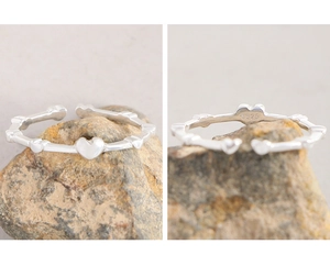 Macro detail showing the S925 silver hallmark and textured heart band of the ring