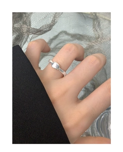 Detailed view of an S925 sterling silver irregular lava bean ring worn on a finger